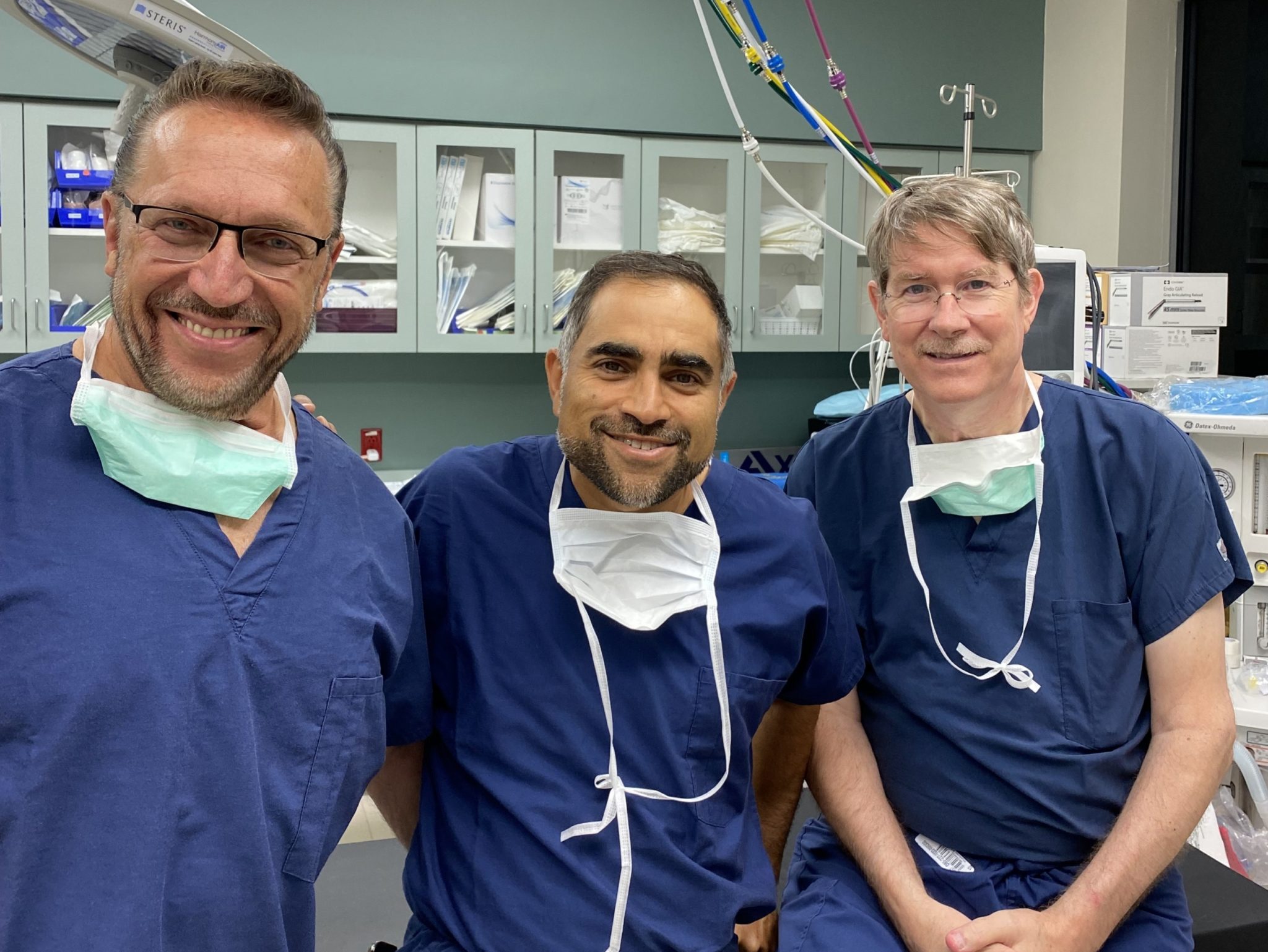 3 clinicians in scrubs smiling